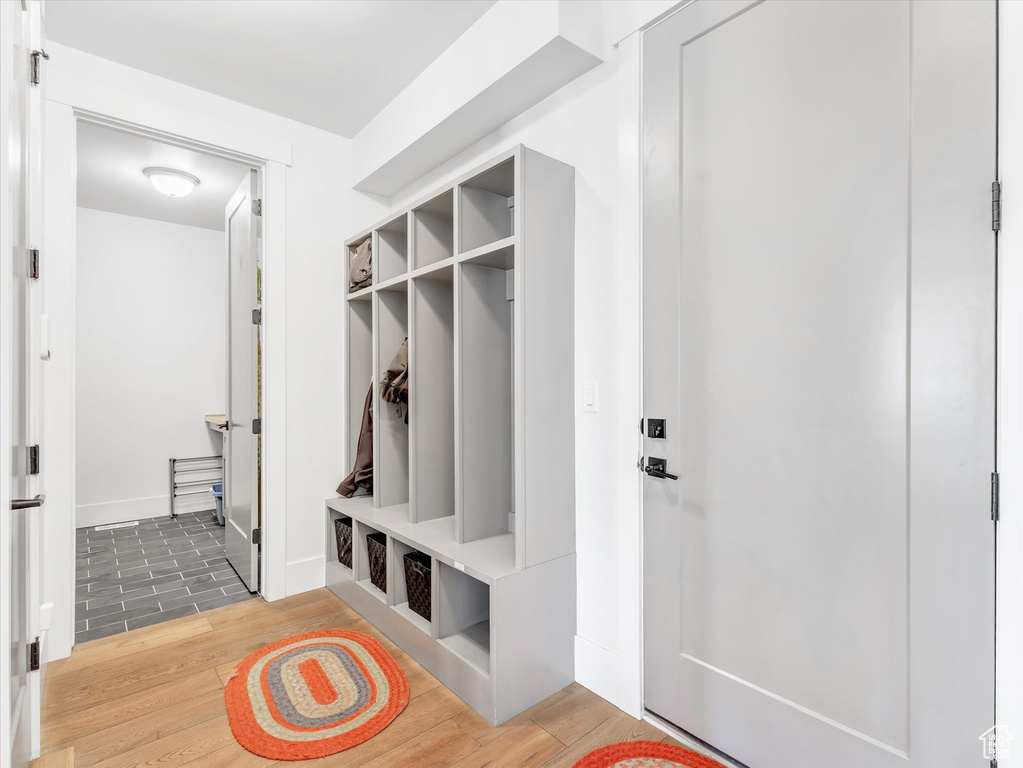 Mudroom featuring light wood-type flooring and baseboards