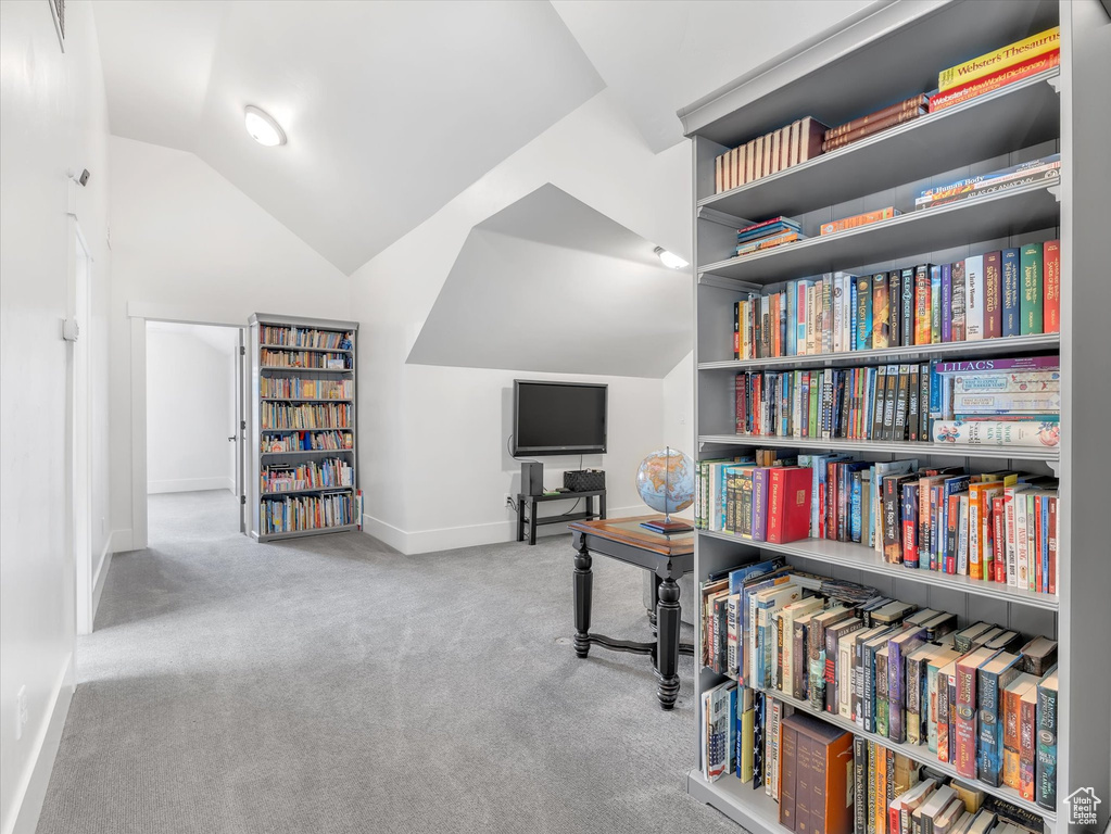 Sitting room with lofted ceiling, baseboards, and carpet floors