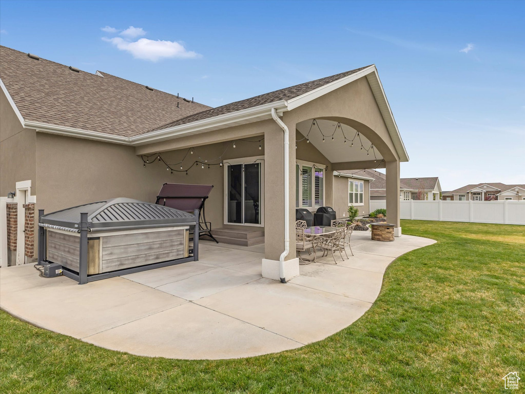 View of patio with a hot tub