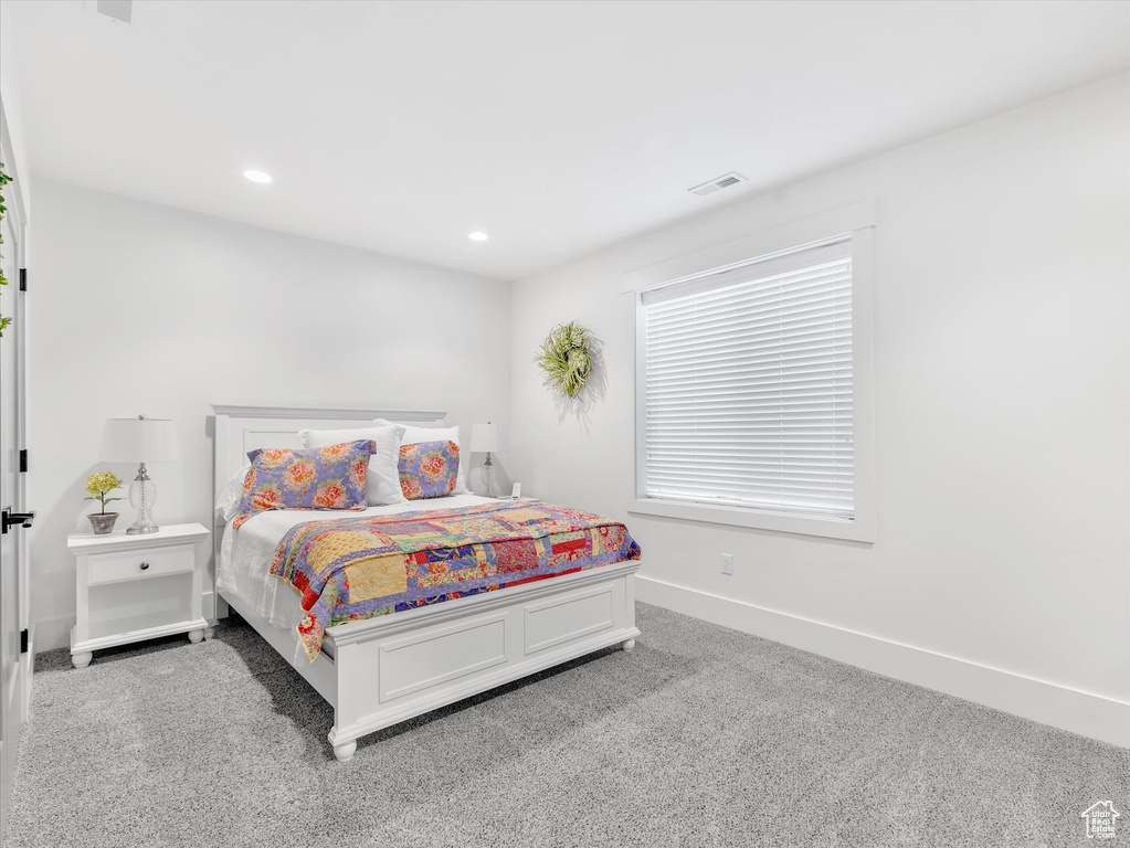 Carpeted bedroom with baseboards and recessed lighting