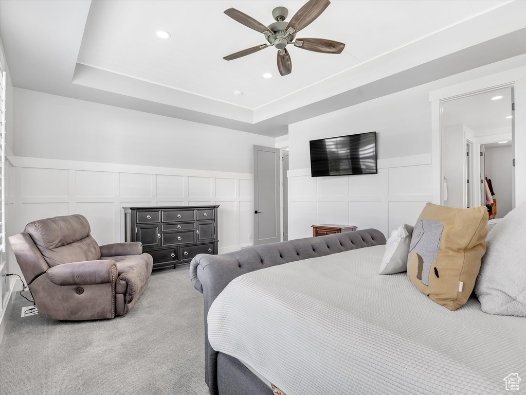 Bedroom with a decorative wall, a wainscoted wall, ceiling fan, recessed lighting, and light colored carpet