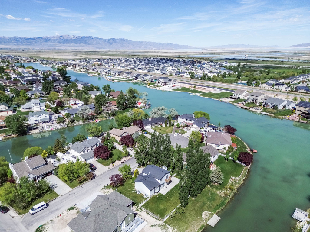 Aerial view of property and surrounding area with nearby suburban area and a water and mountain view