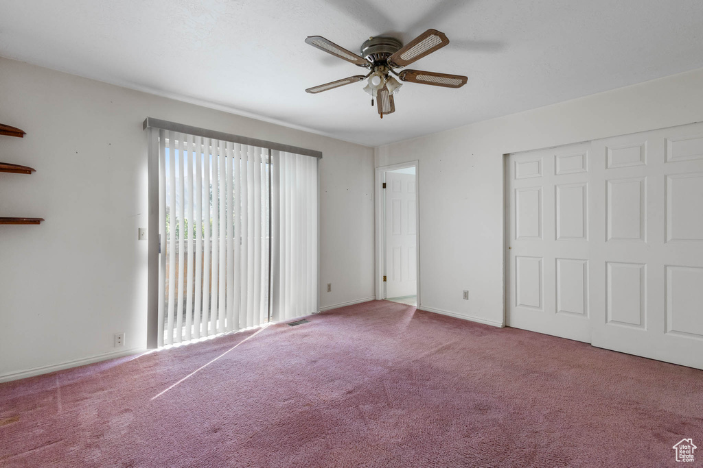 Unfurnished bedroom featuring carpet flooring, a ceiling fan, baseboards, and access to outside