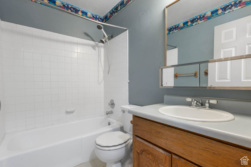 Full bathroom featuring toilet, shower / tub combination, and vanity