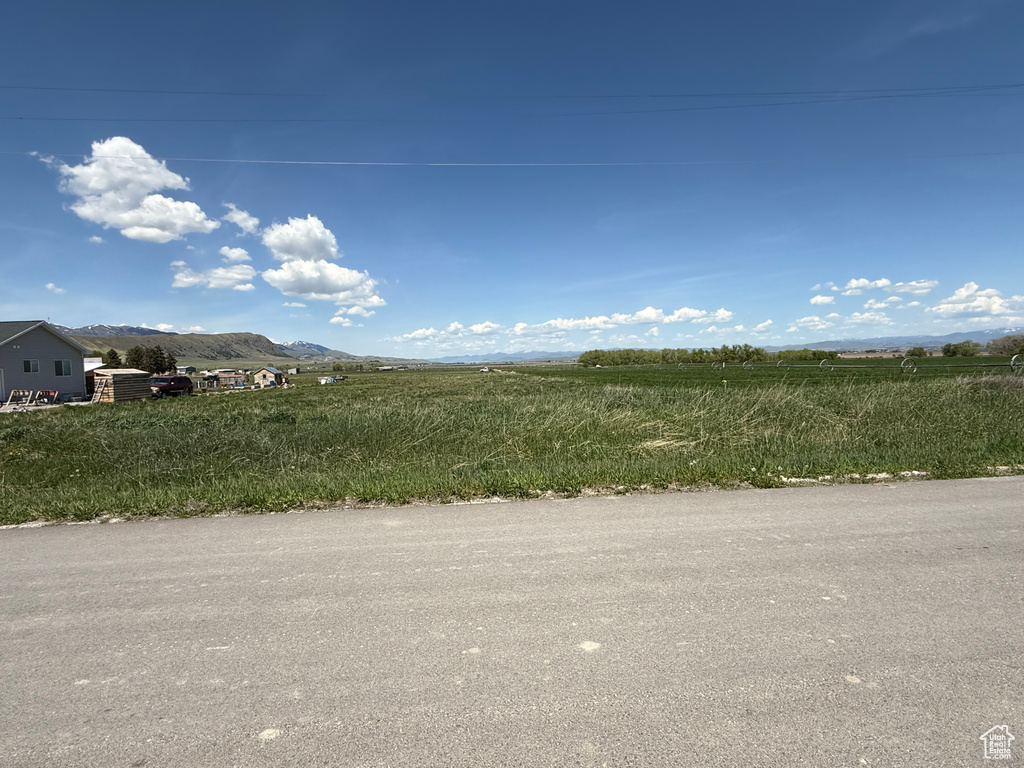 View of asphalt road with a mountain view and a rural view