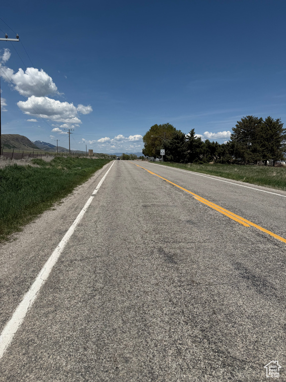 View of asphalt street featuring a mountain view