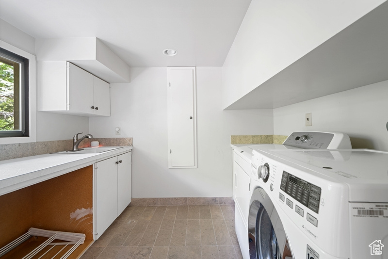 Laundry room featuring independent washer and dryer, cabinet space, baseboards, and recessed lighting