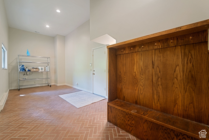 Foyer featuring baseboards, brick patterned floors, and recessed lighting