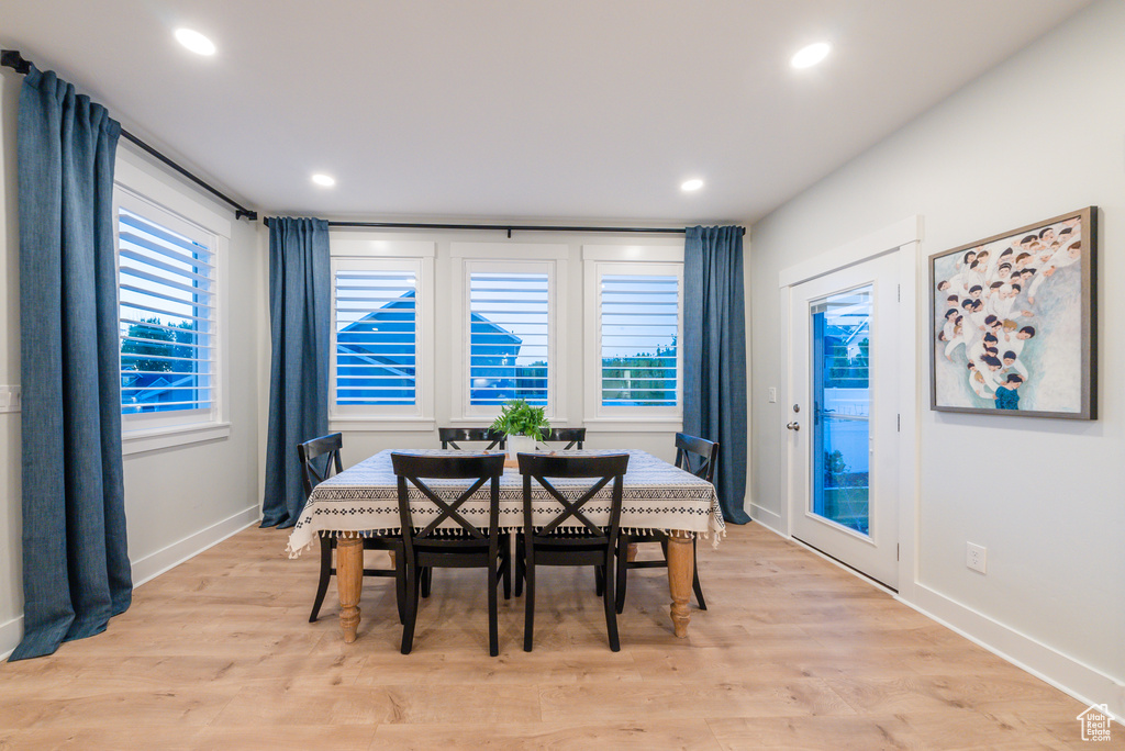 Dining area with baseboards, light wood finished floors, and recessed lighting