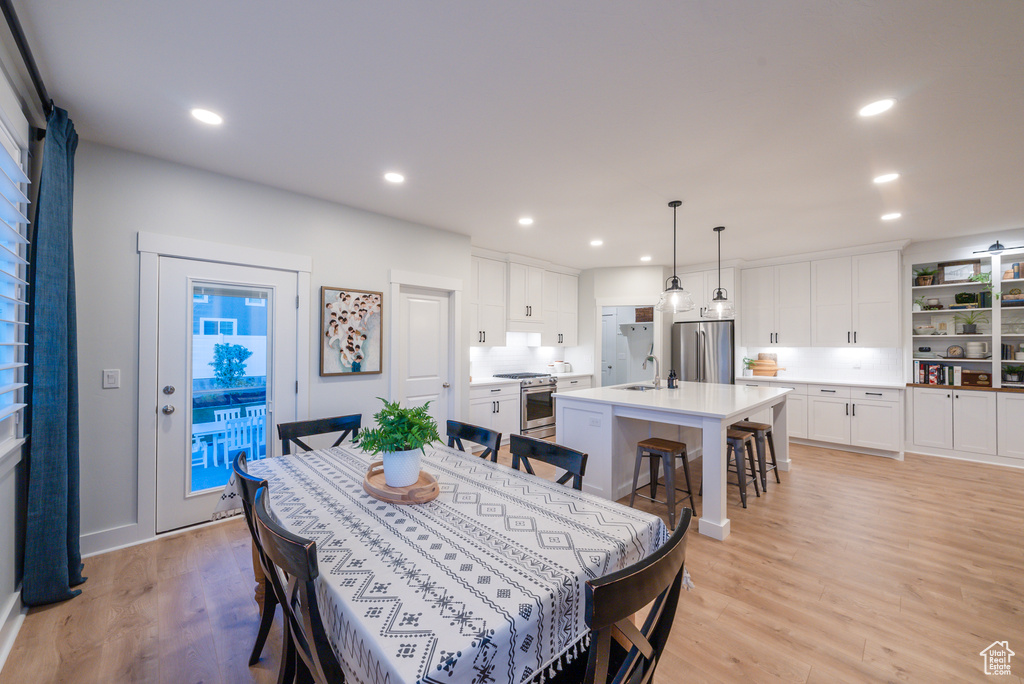 Dining space featuring light wood finished floors and recessed lighting