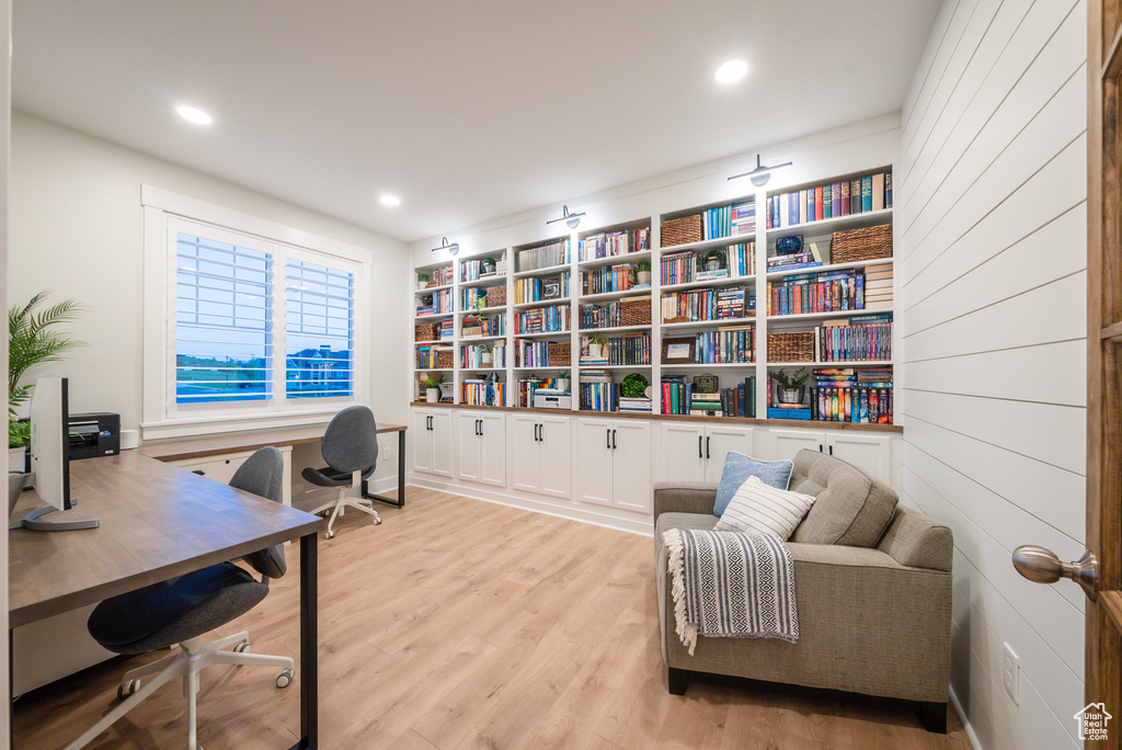 Office with wood finished floors and recessed lighting