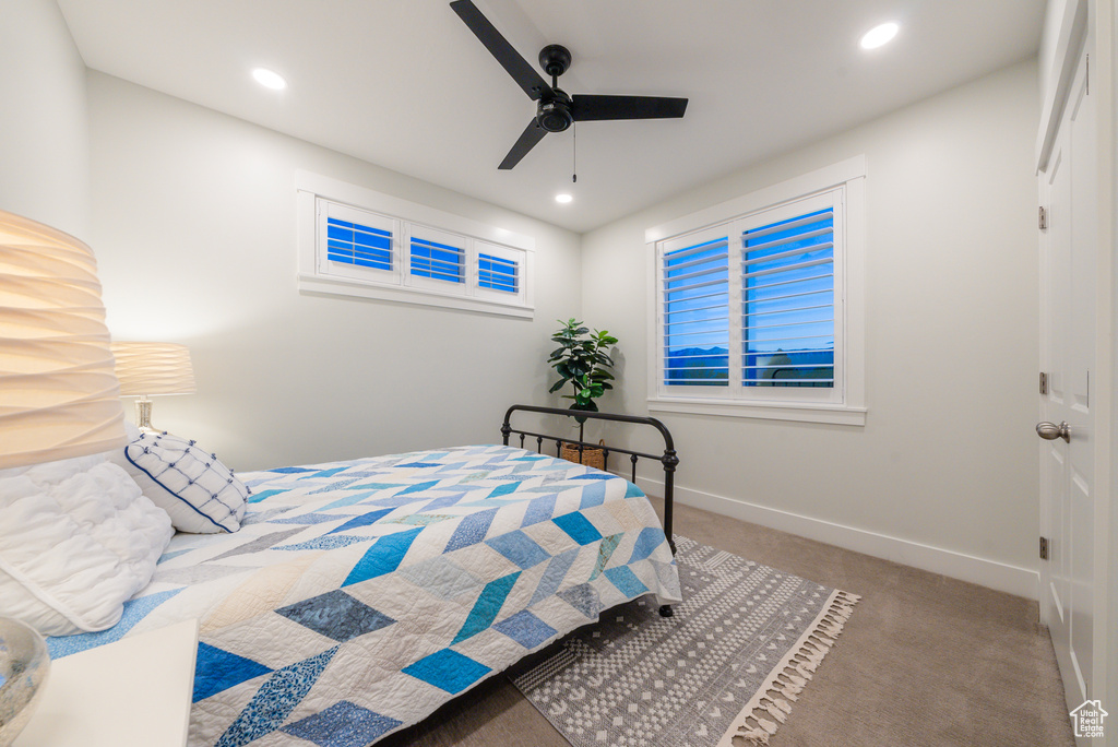 Carpeted bedroom featuring baseboards, recessed lighting, and a ceiling fan