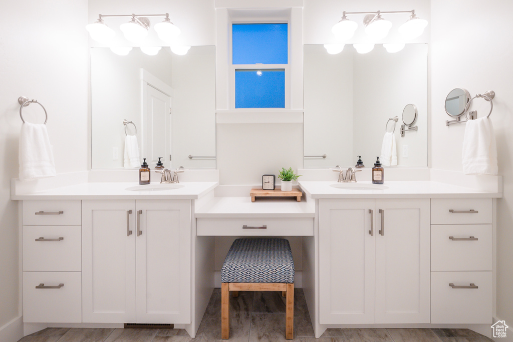 Full bath featuring two vanities and wood finished floors