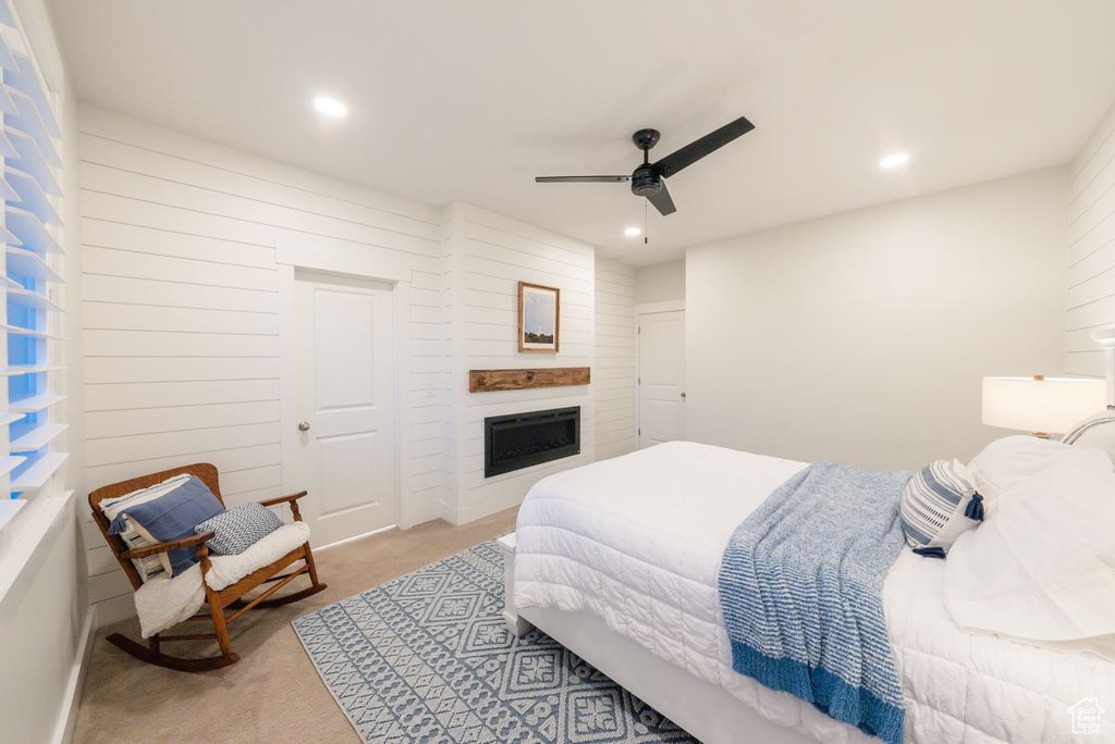Carpeted bedroom with recessed lighting, a fireplace, and a ceiling fan