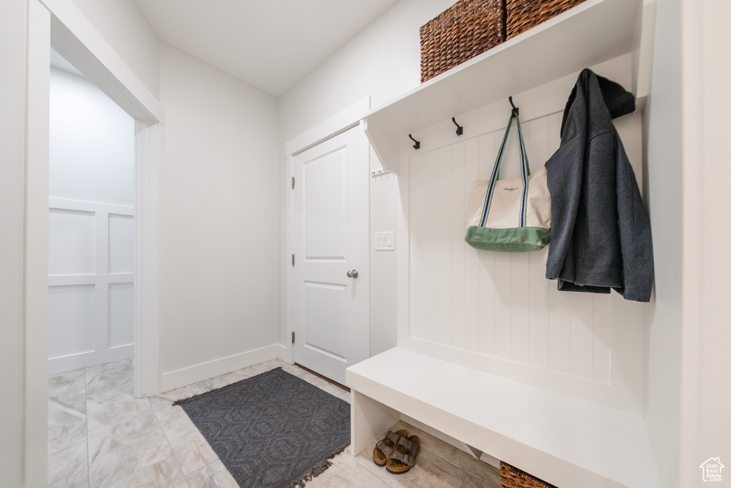 Mudroom with marble finish flooring