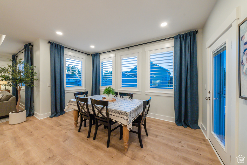 Dining space featuring light wood finished floors, baseboards, and recessed lighting