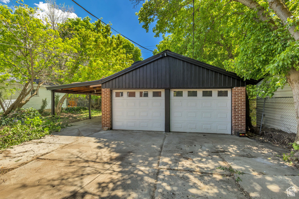 Garage featuring a garage and driveway