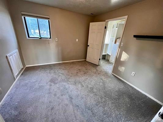 Unfurnished bedroom with baseboards and carpet flooring