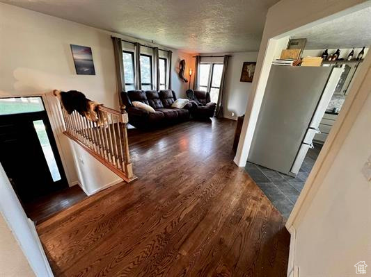 Living area featuring wood finished floors and a textured ceiling