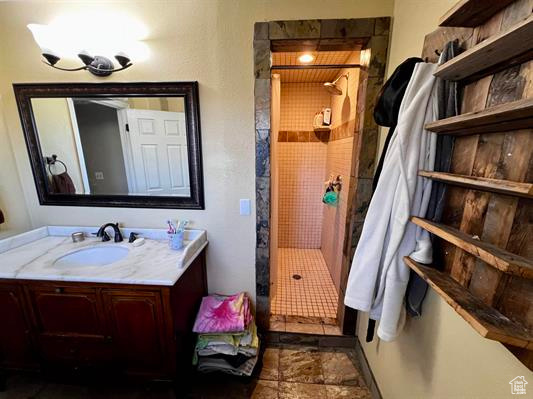 Bathroom featuring a stall shower and vanity