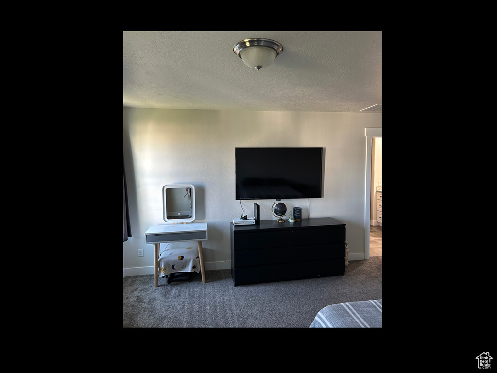 Bedroom with carpet flooring and baseboards