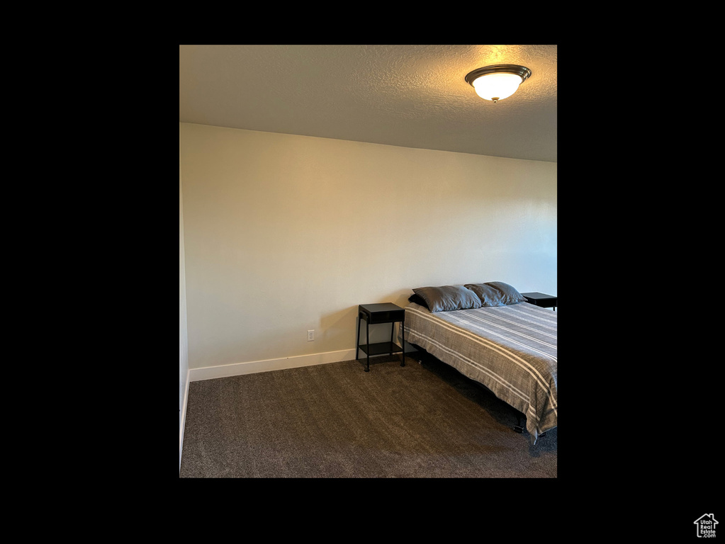 Carpeted bedroom featuring baseboards