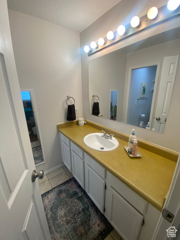 Bathroom with tile patterned flooring and vanity