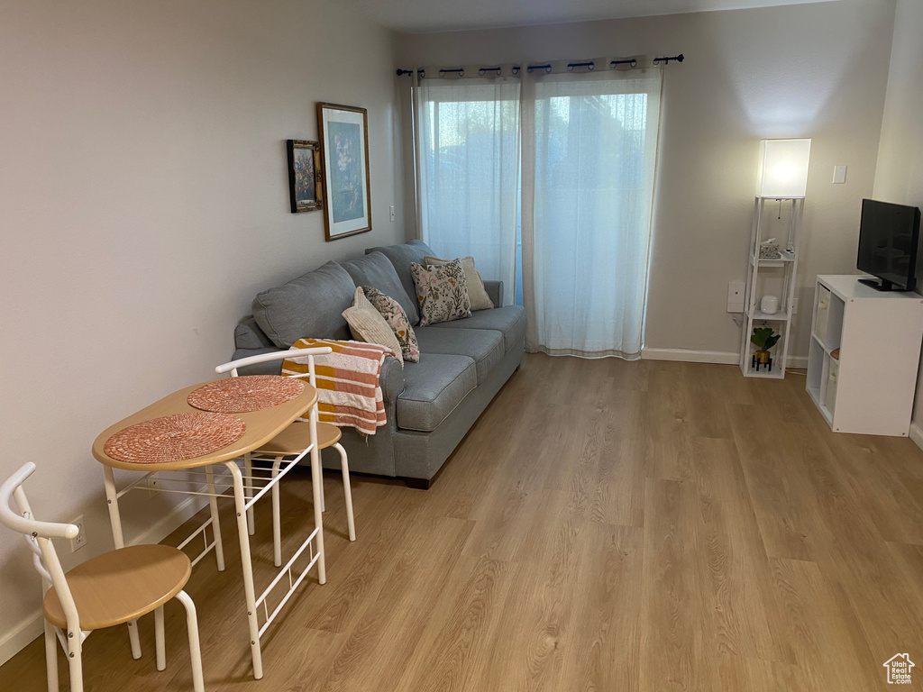 Living area with light wood-style flooring and baseboards