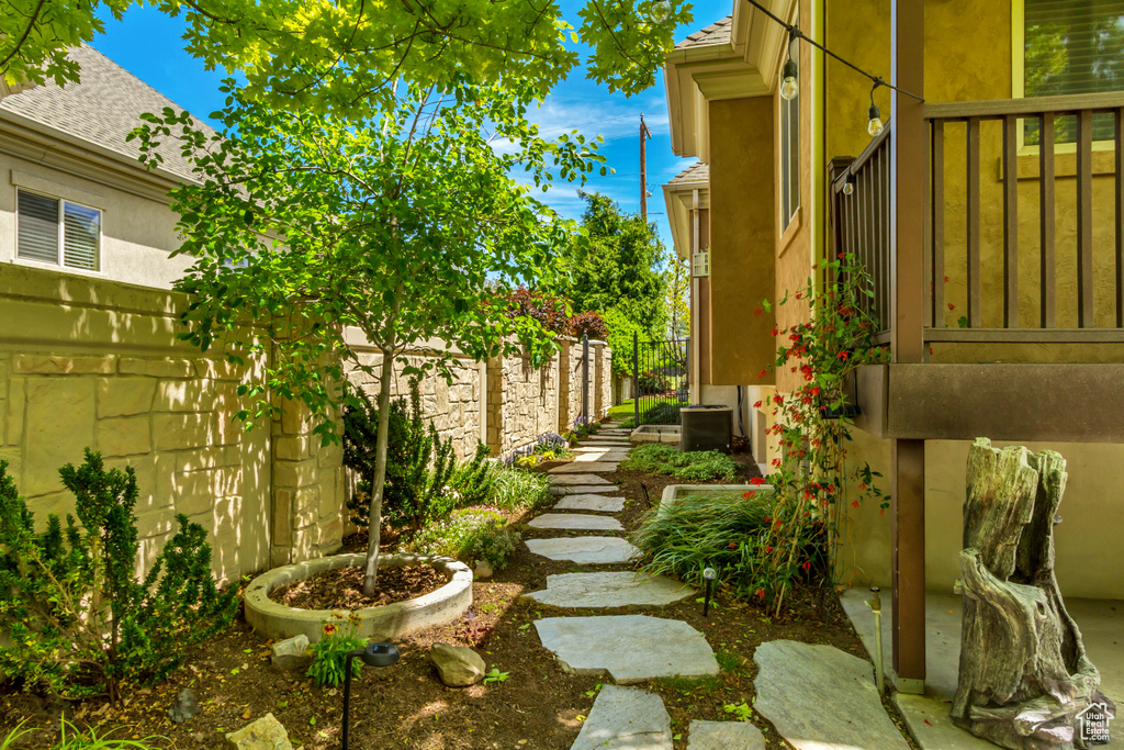 View of yard with fence and central AC