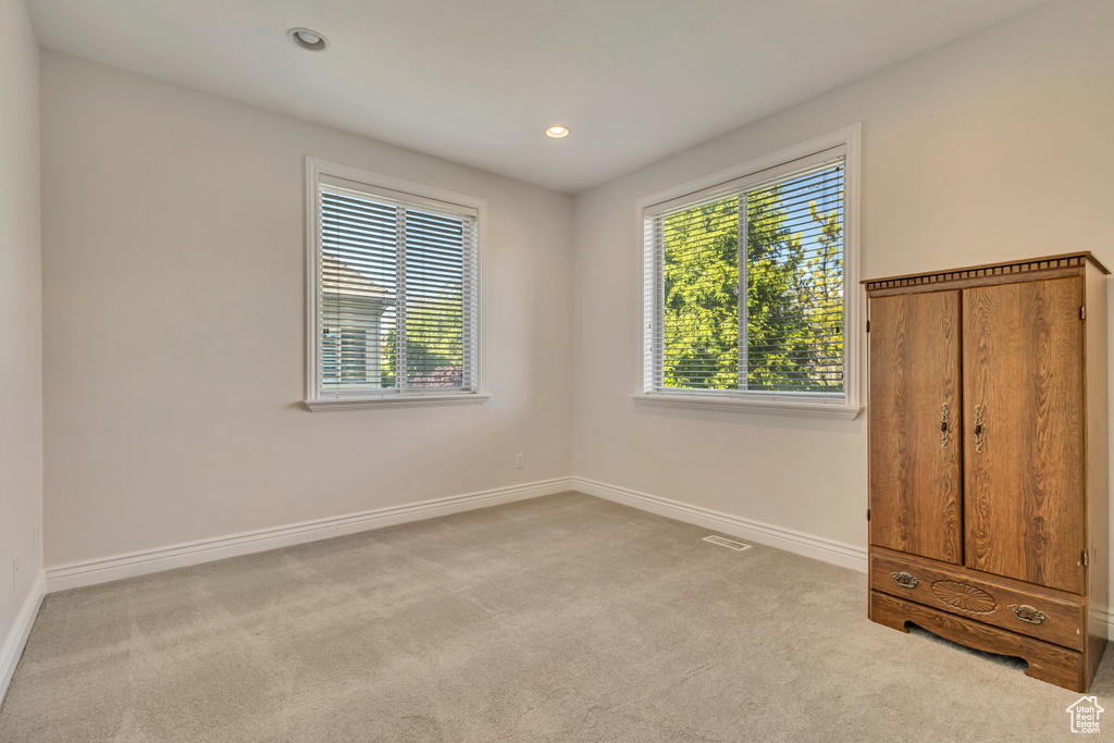 Spare room featuring carpet floors, baseboards, and recessed lighting