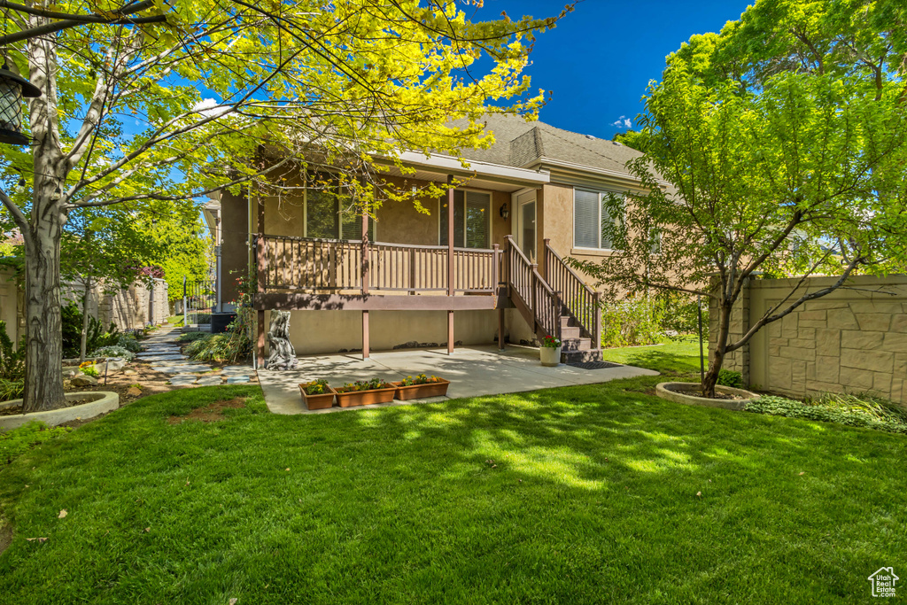Rear view of property featuring a patio area and stucco siding