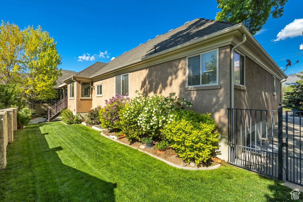 View of side of home featuring stucco siding