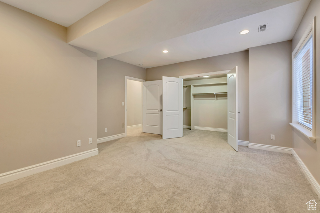 Unfurnished bedroom featuring recessed lighting, light carpet, and baseboards