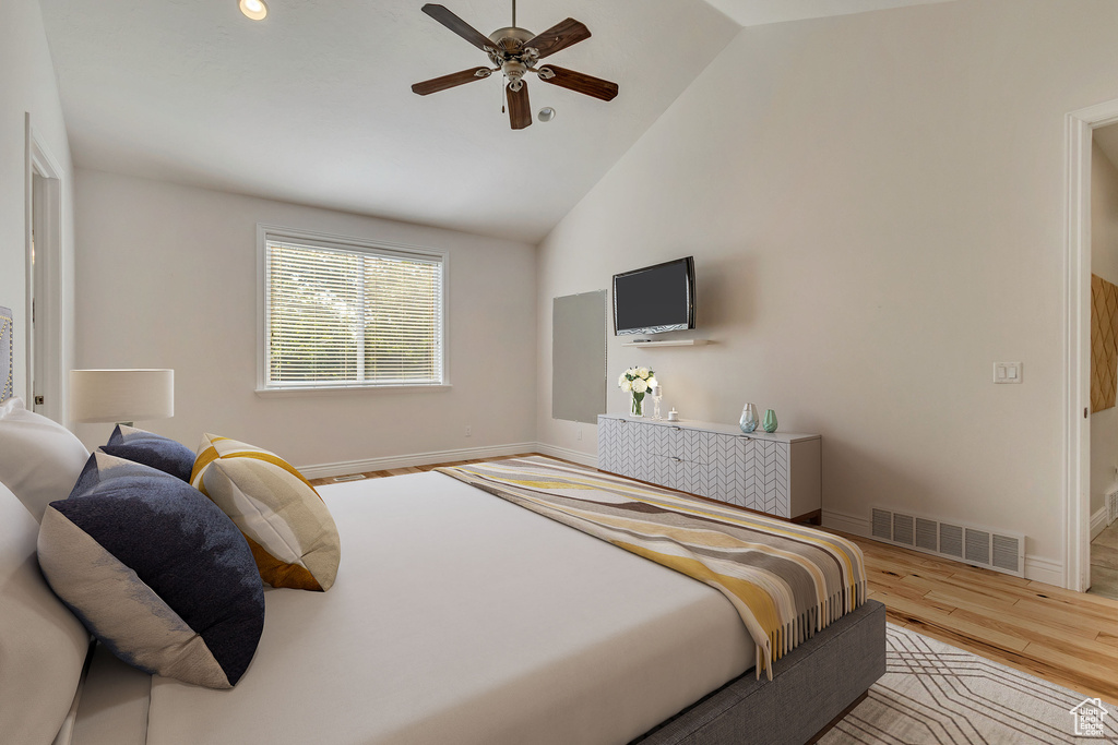 Bedroom featuring wood finished floors, baseboards, high vaulted ceiling, and ceiling fan