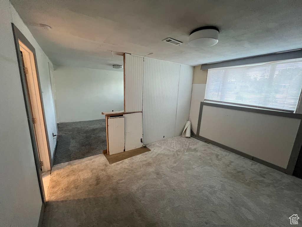 Unfurnished room with carpet