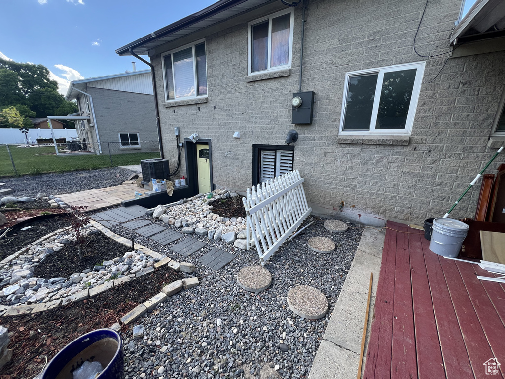 Back of property with fence and central AC unit