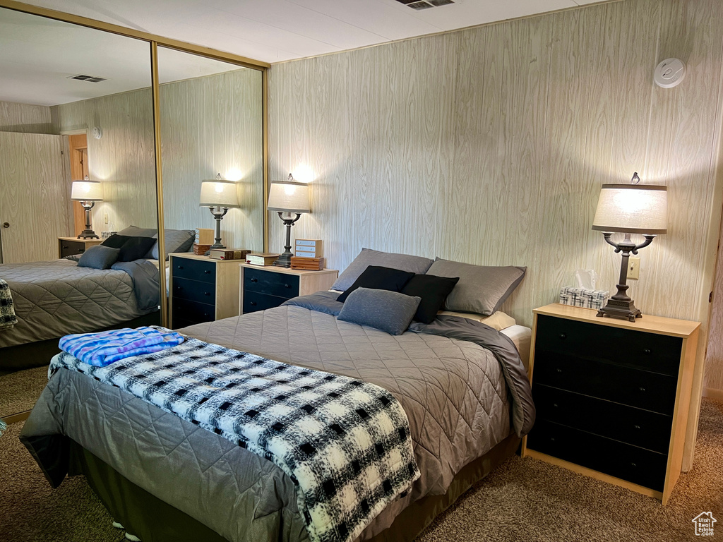 Carpeted bedroom with a closet