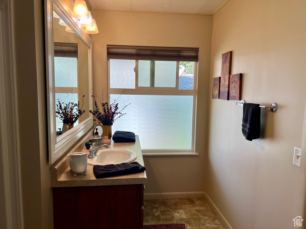 Bathroom featuring vanity and baseboards