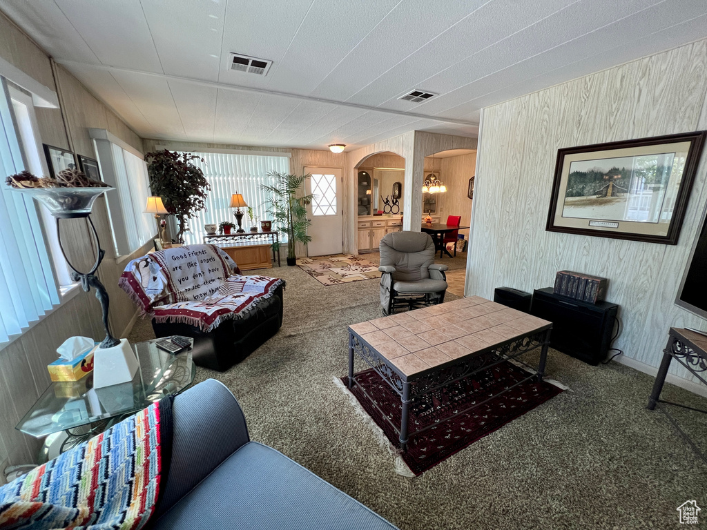 Living room featuring arched walkways and carpet floors