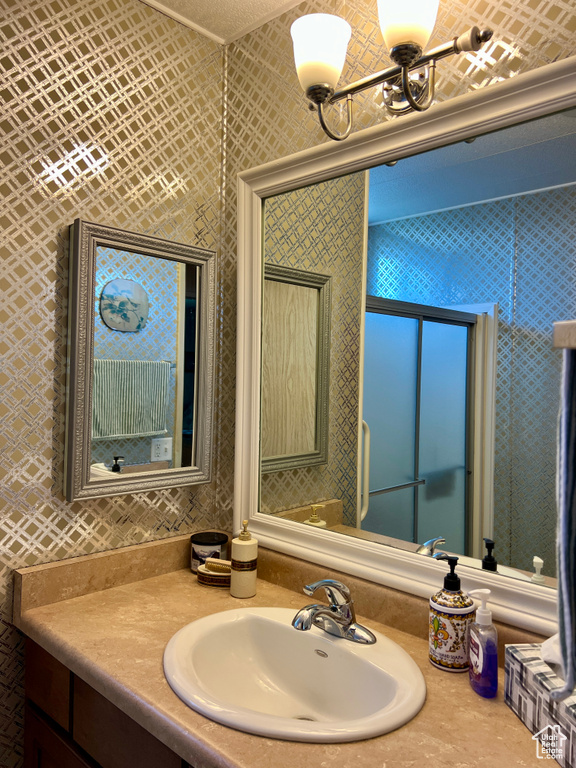Bathroom with vanity and a chandelier