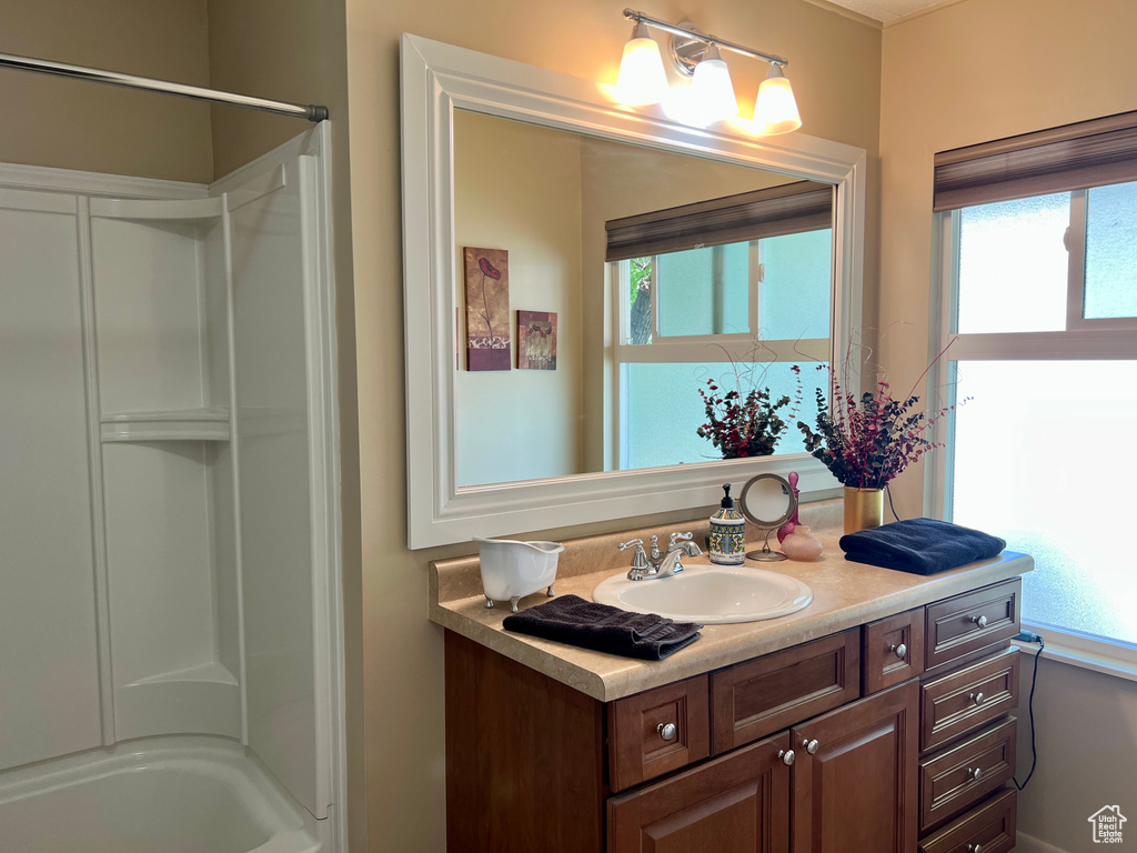 Bathroom featuring vanity and a shower