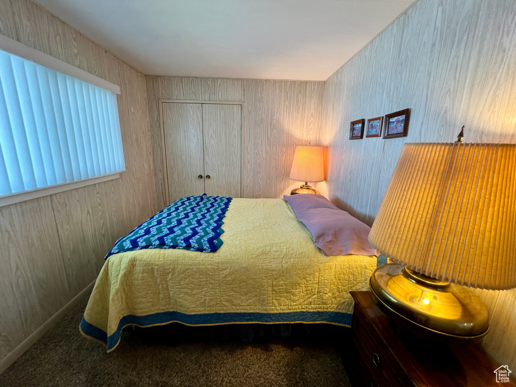 Carpeted bedroom featuring a closet
