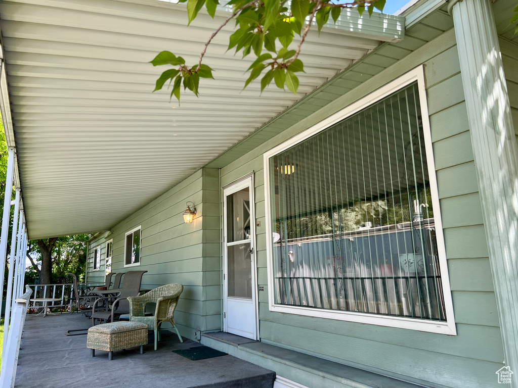 Wooden terrace featuring covered porch