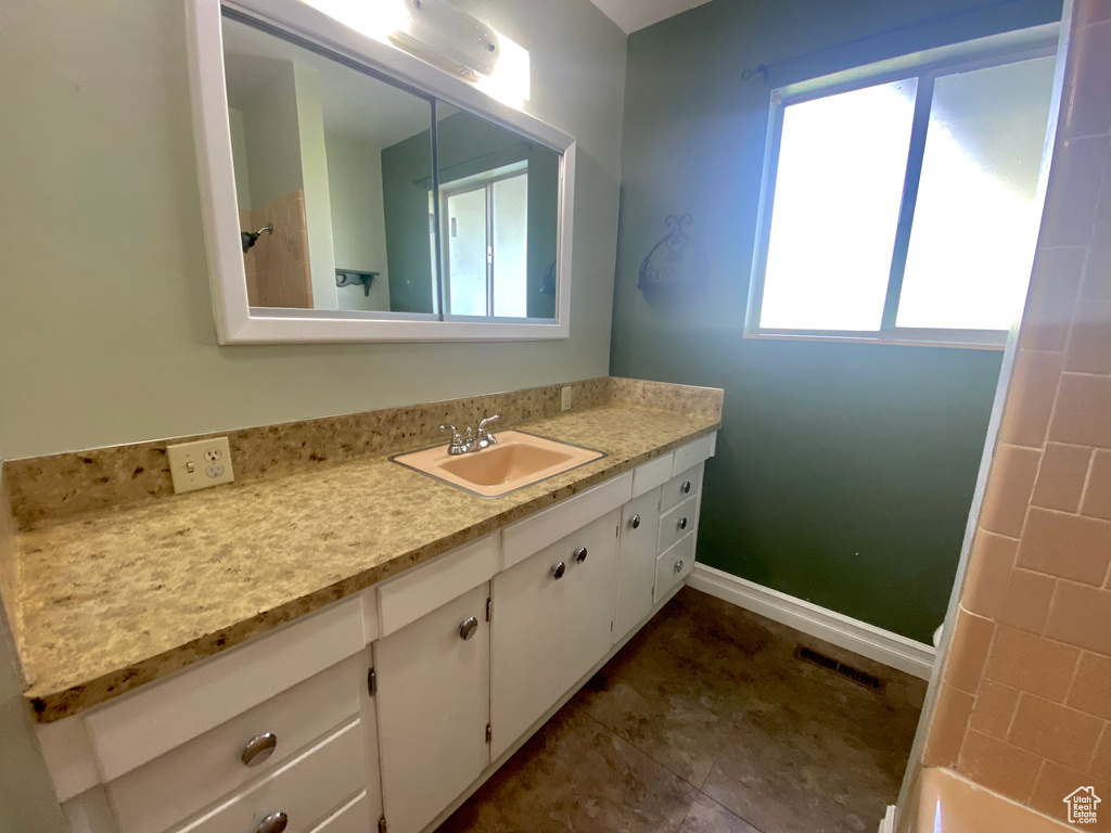 Bathroom with vanity and baseboards