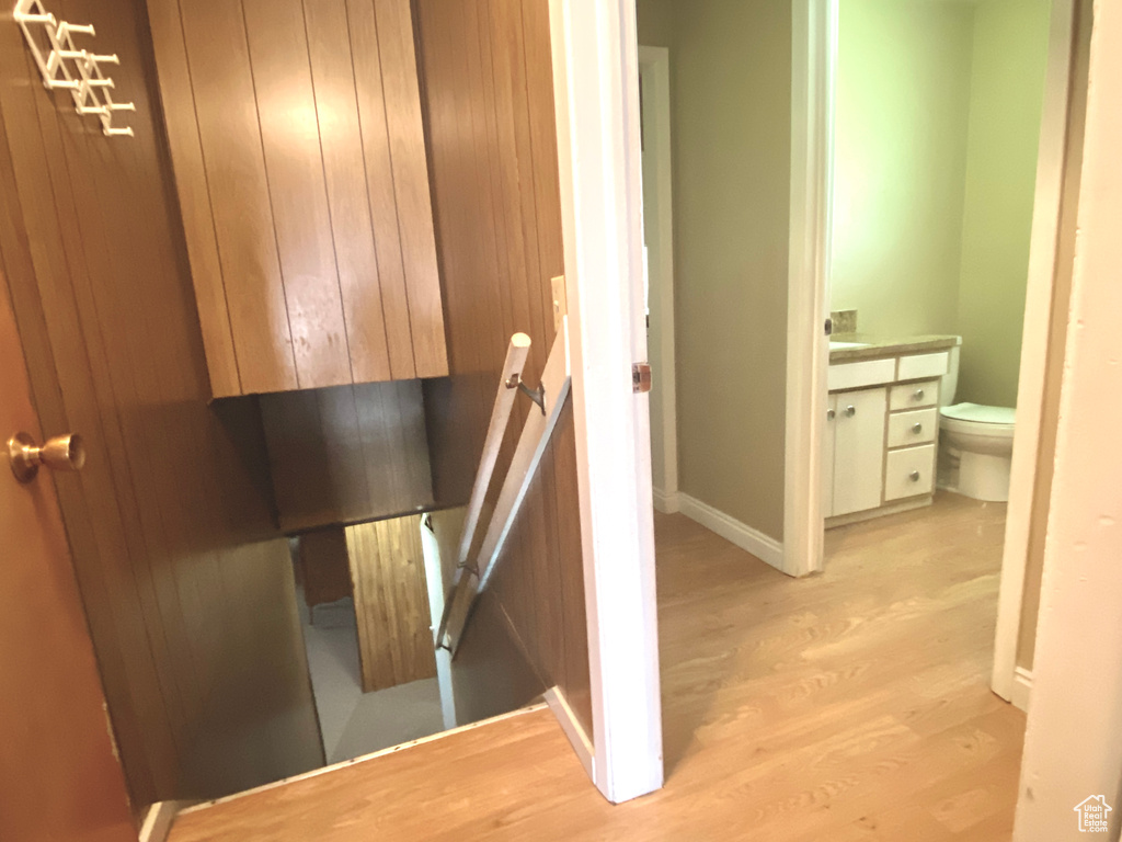 Stairs featuring wood finished floors and baseboards