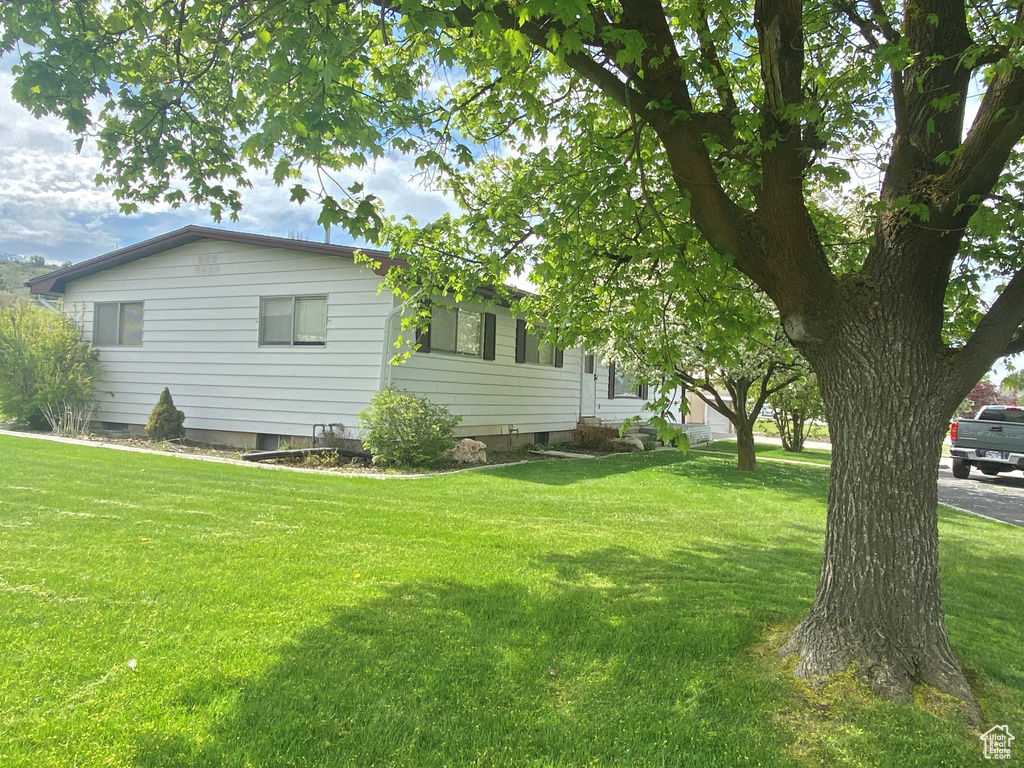 View of home\'s exterior featuring a lawn