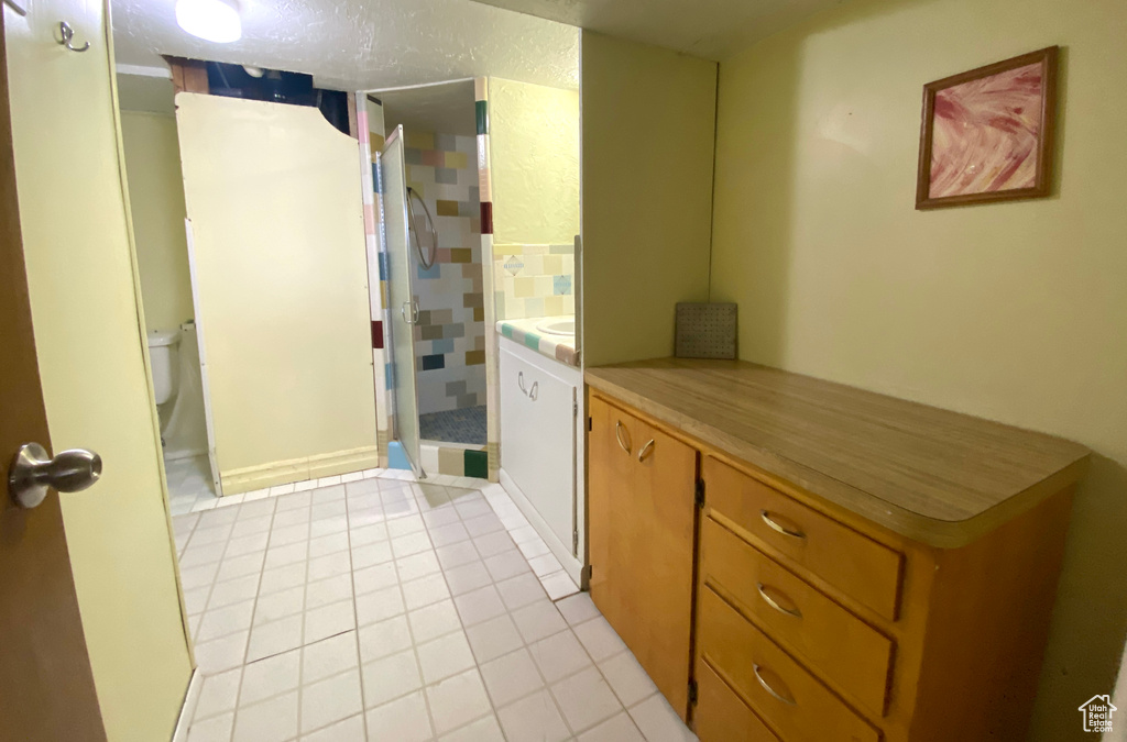Kitchen featuring light tile patterned floors and light countertops