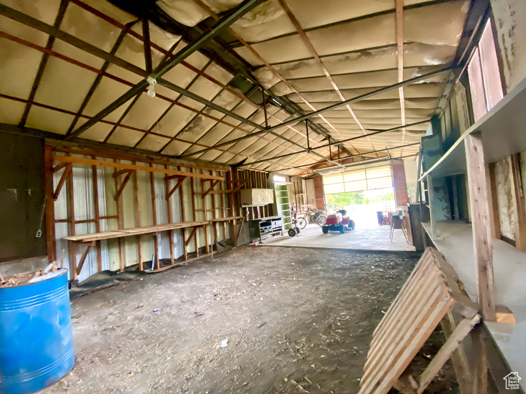 Miscellaneous room with a garage and vaulted ceiling