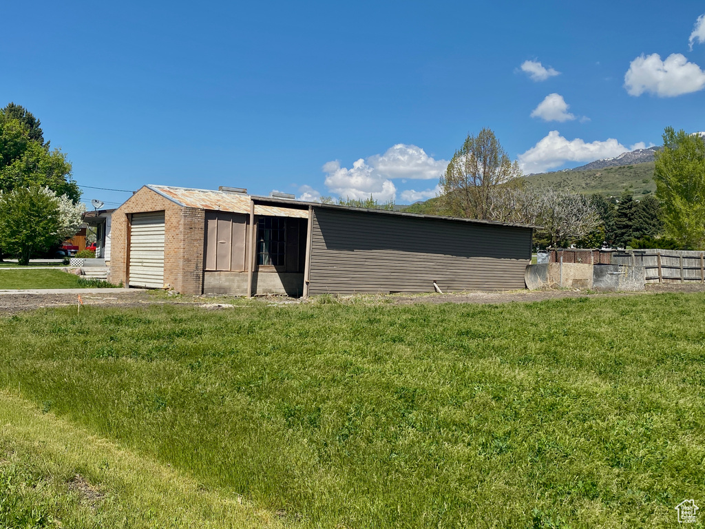 View of outdoor structure with a mountain view and an outbuilding