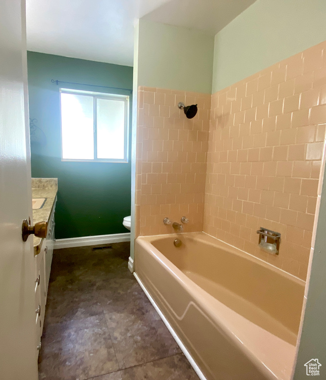 Full bath featuring toilet, shower / bathtub combination, vanity, and baseboards
